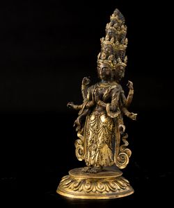 Figura di Ekadasamukha-Avalokitesvara stante su fiore di loto in bronzo parzialmente dorato con tracce di policromia, Cina, Dinastia Qing, XVIII secolo  - Asta Fine Chinese Works of Art - Associazione Nazionale - Case d'Asta italiane