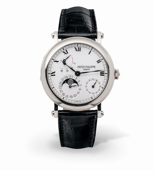 PATEK PHILIPPE : Complicato e classico Calatrava ref 5054 G in oro bianco 18k in perfetto stato di conservazione con cassa a cerniera e fondo a vista, calendario con fasi lunari, quadrante bianco smaltato e numeri Romani, con scatola e garanzia originale  - Asta Orologi da Polso e da Tasca - Associazione Nazionale - Case d'Asta italiane