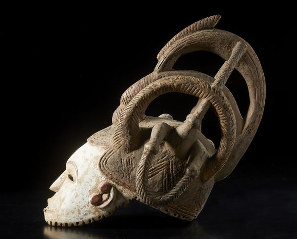 Igbo - Nigeria : Maschera a elmo antropomorfa femminile con elaborata acconciatura. Legno, colino e pigmento.  - Asta Asta 422 | AFRICA, OCEANIA E AMERICHE - ARTIGIANATO AFRICANO: VARI COMMITTENTI E SELEZIONE DALLA COLLEZIONE BARTOLOMUCCI Online - Associazione Nazionale - Case d'Asta italiane