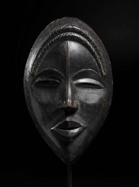 Dan - Costa d'Avorio/Liberia : Maschera antropomorfa con occhi a fessura e treccia frontale. Legno duro a patina nera.  - Asta Asta 422 | AFRICA, OCEANIA E AMERICHE - ARTIGIANATO AFRICANO: VARI COMMITTENTI E SELEZIONE DALLA COLLEZIONE BARTOLOMUCCI Online - Associazione Nazionale - Case d'Asta italiane