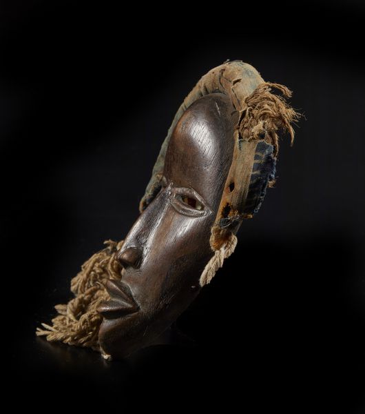 Dan - Costa d'Avorio/Liberia : Maschera antropomorfa. Legno a patina marrone, corda e fibre.  - Asta Asta 422 | AFRICA, OCEANIA E AMERICHE - ARTIGIANATO AFRICANO: VARI COMMITTENTI E SELEZIONE DALLA COLLEZIONE BARTOLOMUCCI Online - Associazione Nazionale - Case d'Asta italiane