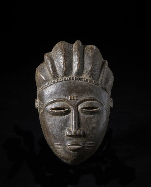 Baule - Costa d'Avorio : Maschera antropomorfa. Legno duro a patina scura.  - Asta Asta 422 | AFRICA, OCEANIA E AMERICHE - ARTIGIANATO AFRICANO: VARI COMMITTENTI E SELEZIONE DALLA COLLEZIONE BARTOLOMUCCI Online - Associazione Nazionale - Case d'Asta italiane