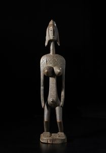 Bambara - Mali - Scultura antropomorfa femminile. Legno duro a patina scura.