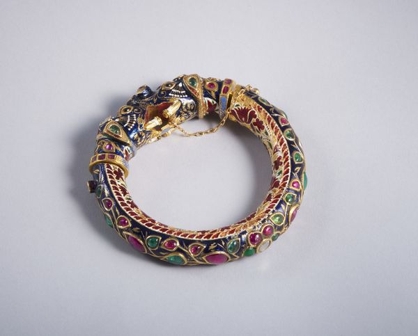 . : Raro e particolare  bracciale  indiano in lamina d'oro rappresentate due teste di elefante con smalti policromi, rubini, smeraldi e diamanti taglio a rosa. XIX secolo.  - Asta GIOIELLI - OROLOGI - ALL I WANT FOR CHRISTMAS Online - Associazione Nazionale - Case d'Asta italiane