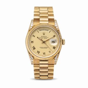 ROLEX - Raro e prezioso Daydate ref 18338 in oro giallo 18k con diamanti incastonati sulle anse, quadrante champagne opaco con numeri Romani applicati corredato di garanzia originale