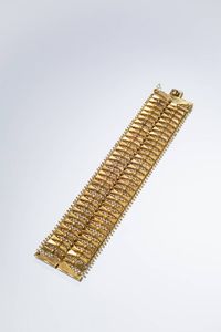 BRACCIALE - Peso gr 70 Lunghezza cm 18 in oro giallo  anni '50  lavorato a maglia a rete con elementi geometrici.