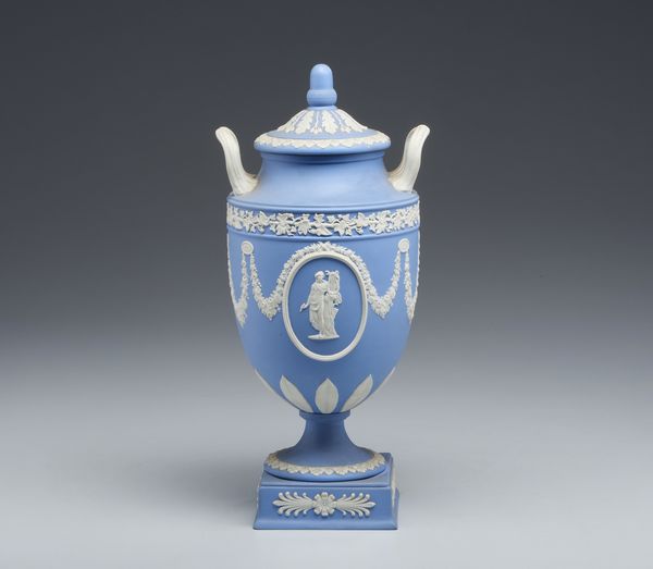 MANIFATTURA DI WEDGWOOD, XX SECOLO : Urna 'all'antica' in ceramica azzurra e bianca con ghirlande floreali e fitomorfe, corpo centrato da figure di Apollo e di una Musa  - Asta Asta 449 | ARTE ANTICA E DEL XIX SECOLO Virtuale - Associazione Nazionale - Case d'Asta italiane