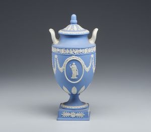 MANIFATTURA DI WEDGWOOD, XX SECOLO : Urna 'all'antica' in ceramica azzurra e bianca con ghirlande floreali e fitomorfe, corpo centrato da figure di Apollo e di una Musa  - Asta Asta 449 | ARTE ANTICA E DEL XIX SECOLO Virtuale - Associazione Nazionale - Case d'Asta italiane