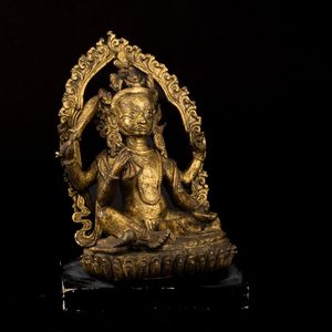 Figura di Mahakala seduto su fior di loto entro aura in bronzo dorato, Nepal, XVII secolo  - Asta Fine Asian Works of Art - Associazione Nazionale - Case d'Asta italiane