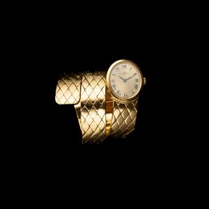 Baume & Mercier : Serpenti in oro giallo 18k tre giri, quadrante Champagne numeri Romani, movimento a carica manuale  - Asta Orologi da Polso - Associazione Nazionale - Case d'Asta italiane