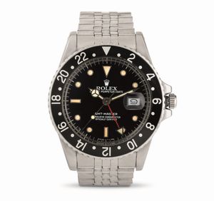 ROLEX - GMT Master ref 16750, in acciaio con ghiera girevole bidirezionale nera, quadrante nero indici bicchierini, bracciale in acciaio Jubilee, accompagnato da garanzia