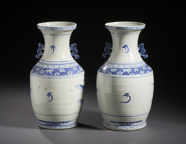 Arte Cinese : Coppia di vasi in porcellana bianco blu dalla forma a colonna di balaustra dipinti con personaggi in un giardino, manici applicati sul collo del vaso.Cina XX sec.  - Asta Asta 470 | ARTE ORIENTALE Online - Associazione Nazionale - Case d'Asta italiane