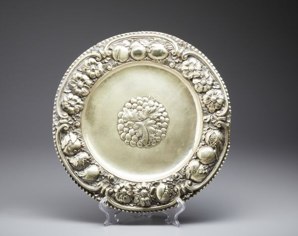 ARGENTIERE ITALIANO DEL XX SECOLO : Piatto in argento sbalzato con bordo decorato con festoni di frutta a rilievo, centrato da decoro a grappolo d'uva  - Asta Asta 469 | ARTE ANTICA E DEL XIX SECOLO Online - Associazione Nazionale - Case d'Asta italiane