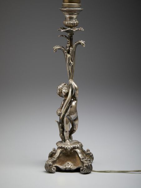 ARGENTIERE ITALIANO DEL XX SECOLO : Lampada in argento con fusto in foggia di putto che sorregge uno stelo vegetale, base poggiante su piedi a ricciolo  - Asta Asta 472 | ARTE ANTICA E DEL XIX SECOLO Virtuale - Associazione Nazionale - Case d'Asta italiane